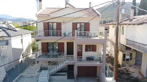 a white house with stairs in a city at Villa Melydron in Nafplio