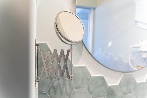 a mirror on a wall in a bathroom at Antica Loggia in Vibo Valentia