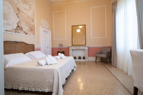 a bedroom with two beds and a mirror at Antica Loggia in Vibo Valentia