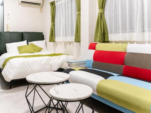 a room with two beds and two tables at Asakusa 4min walk, 8min to Senso-ji Temple, 5min to Ueno,4 min to Kappabashi, Switch, Free Wi-Fi, PocketWi-Fi in Tokyo