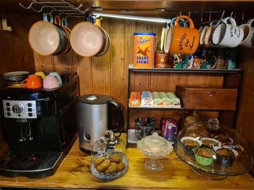 a kitchen counter with a coffee maker and coffee cups at Le Grand Cèdre Spa et sauna intérieur piscine in Marolles