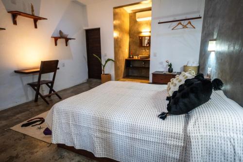 a bedroom with a bed with a black bird on it at Casa Monika in Puerto Escondido