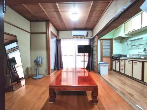 a room with a wooden table in a kitchen at Old style japanese house Minpaku Yanoya in Otsu