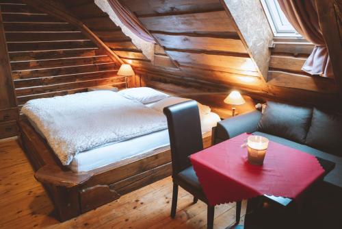 a bedroom with a bed and a table with a cup of coffee at Penzion Sklípek in Staré Splavy