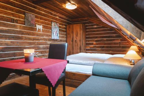 a room with a bed and a table with a table at Penzion Sklípek in Staré Splavy