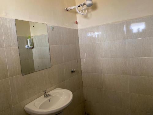 a bathroom with a sink and a mirror at Kajiado Homes 2 in Kajiado