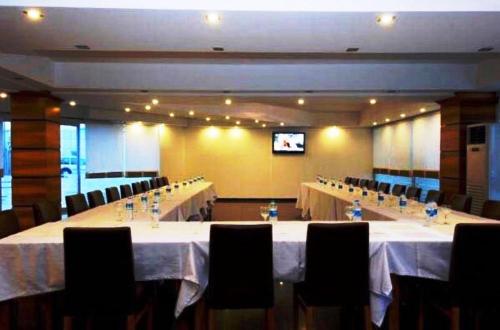a conference room with tables and chairs and a television at Expo Park Hotel in Antalya