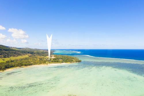 an island with a white tower in the water at Le Cabanon in Choisy
