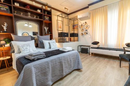 a bedroom with a large bed and a living room at Vaios Art Residence in Athens