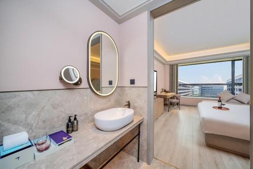 a bathroom with a sink and a mirror at Mercure Guangzhou Baiyun International Airport - Airport Free Shuttle Bus in Huadu
