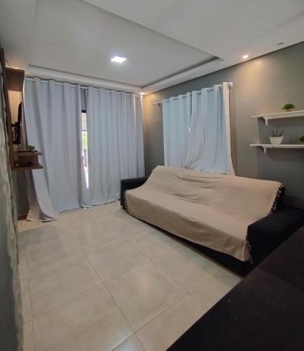 a bedroom with a bed with white drapes at POUSADA e HOTEL FLORESTA AMAZÔNICA in Nova Emprêsa