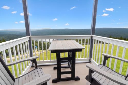 a table and two chairs on a balcony with a view at ML254 Close To Village And Slopes EZ Parking Wi-Fi in Dunmore