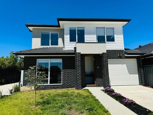a house with a black and white at Cozy room in Melbourne in Sunshine