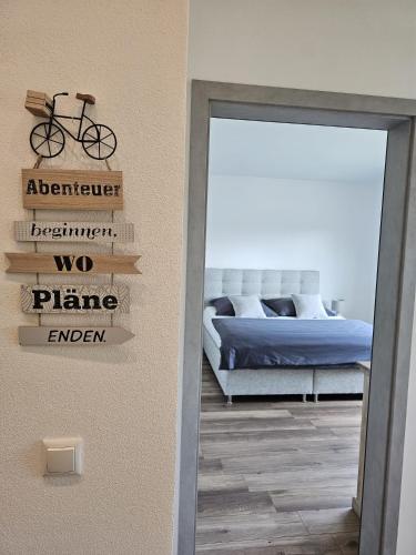 a bedroom with a bed and a sign with a bike on it at MV Römervilla, Lofts & Penthouses mit traumhaftem Moselpanoramablick und Sauna in Treis-Karden