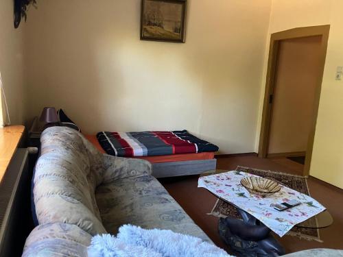 a living room with a couch and a bed at Doppelzimmer vom Friesenhof Wieratal in Nobitz