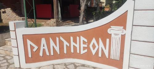 a sign for a restaurant in front of a building at PANTHEON HALL HOTEL in Mesongi