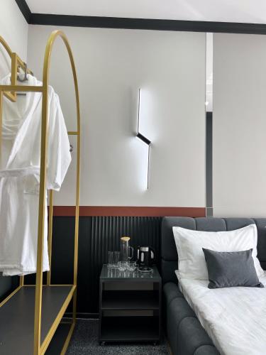 a hotel room with a bed and a mirror at Suncor Hotel in Karakol