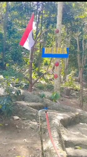 a street sign with a flag and a pole at Diara Bungalow in Iboih