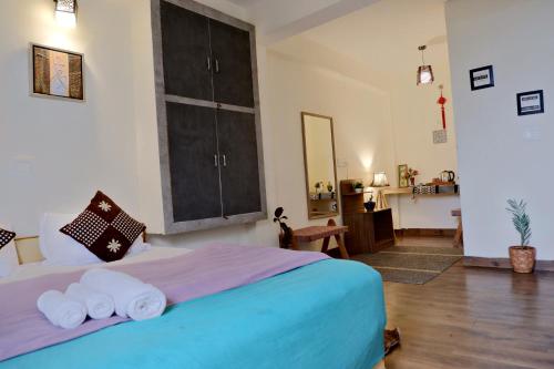 a bedroom with a bed with towels on it at Utopia Hostels Dharamkot Mcleodganj in Dharamshala