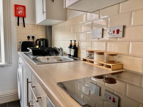 a kitchen with a sink and a counter at Apartment 2 in Blackpool