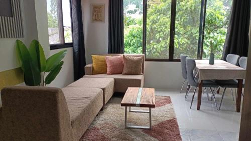 a living room with a couch and a table at Gensan Apartment in Dulongabong