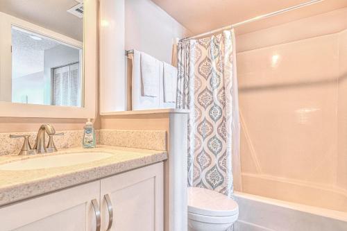 a bathroom with a sink and a toilet and a shower at Ocean Trillium 803 - A 1 Bedroom Condo With Beautiful Ocean Views in New Smyrna Beach