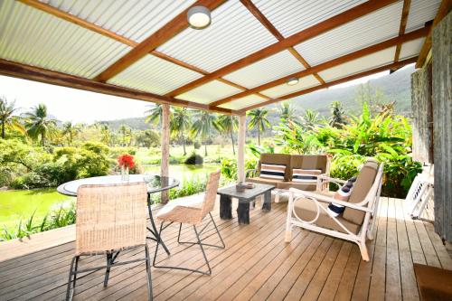 a patio with chairs and a table on a deck at Le Cabanon in Choisy
