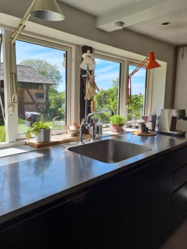 a kitchen counter with a sink and a window at Huset i Oreby in Sakskøbing