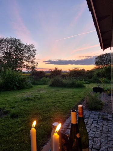 a group of bottles of wine and candles on a patio at Huset i Oreby in Sakskøbing