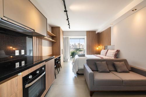a bedroom with a bed and a couch in a room at Studio na V. Clementino, decorado e aconchegante in Sao Paulo
