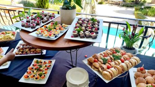 a table filled with different types of food on plates at Midrand Conference Centre in Midrand