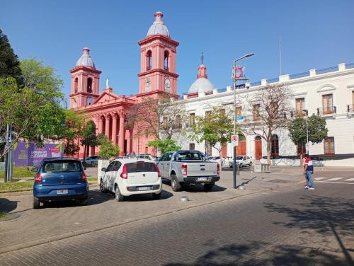 a street with cars parked in front of a building at Departamento a 150 metros de la catedral con cochera in San Fernando del Valle de Catamarca