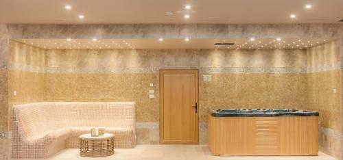 a bathroom with a tub and a sink at Gardenia Hotel & Spa in Veles