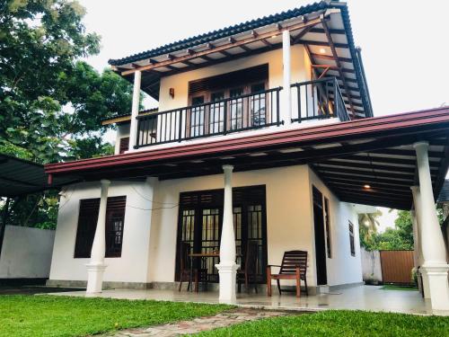 a house with a balcony on top of it at Kottamba Villa Tangalle in Tangalle