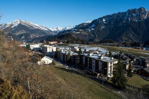 an aerial view of a town with mountains in the background at Alpine Classic Hotel in Leysin