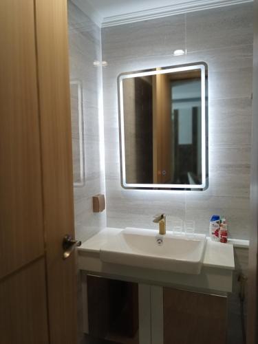 a bathroom with a white sink and a mirror at Dusit grand park 2 in Jomtien Beach