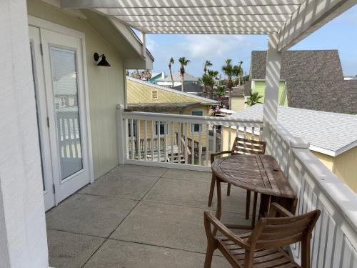 a patio with a table and chairs on a balcony at Seashell Village Resort near the beach with kitchens in Port Aransas