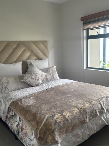 a bed in a white room with a window at Mya Villa 2 in Fourways