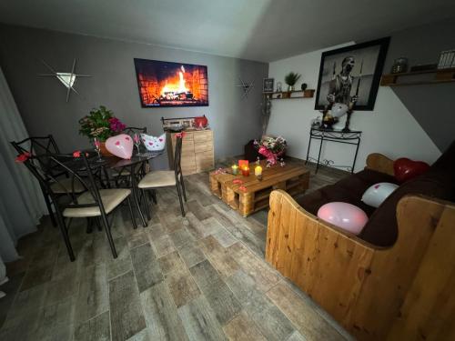 a living room with a couch and a table with candles at Gîte chez carline classé meublés du tourisme 3 étoiles in Fultot