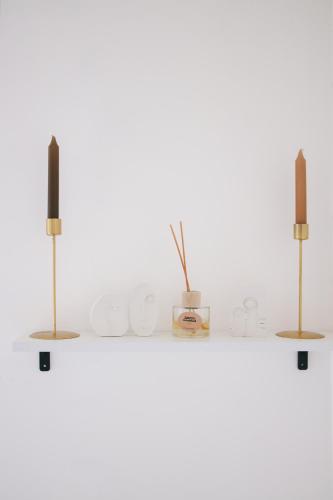 a shelf with two candles on top of it at Buna Guest House in Gyumri