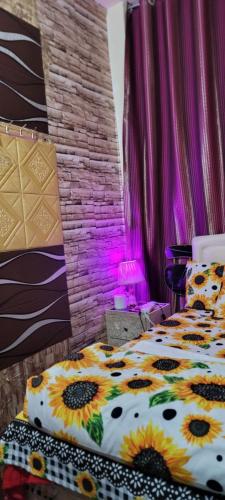 a bedroom with a bed with sunflower pillows at MAMA DELiGHT HOME in Abu Dhabi