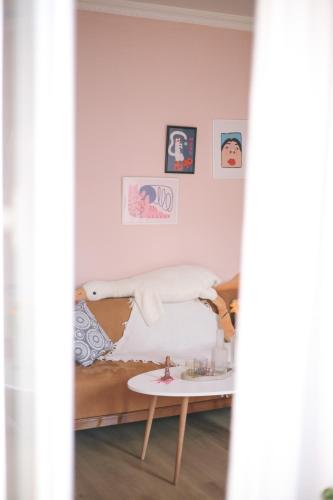 a room with a bed and a table with pillows at Buna Guest House in Gyumri