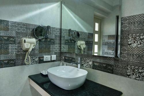 a bathroom with a sink and a mirror at Buki Boutique Hotel Lazimpat in Kathmandu