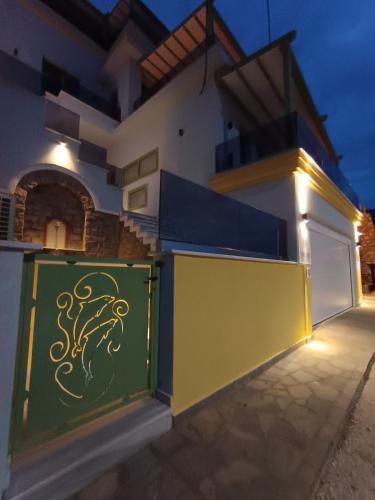 a building with a green gate with a dragon painted on it at Karnayo apartments in Kavala