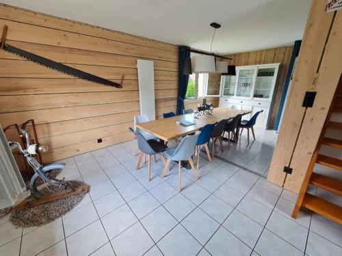 a kitchen and dining room with a table and chairs at La Magie entre deux lacs in Gérardmer
