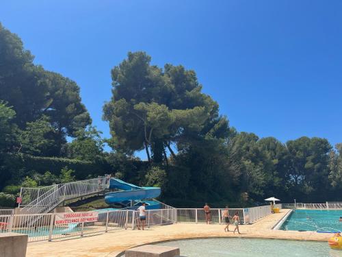 a water park with a slide and people in a pool at Les jardins de la Méditerranée in Six-Fours-les-Plages