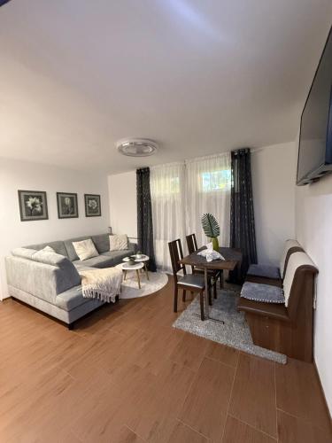a living room with a couch and a table at Apartmán Carat in Banka