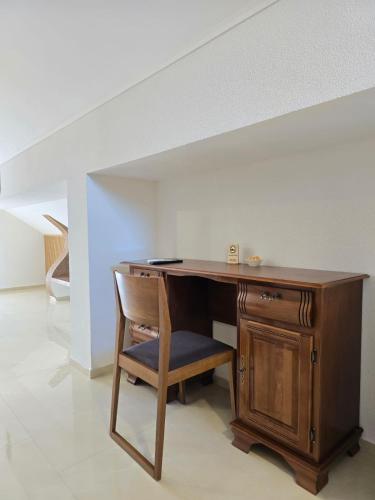 a wooden desk with a chair in a room at Hotel Mažijanik in Nikšić