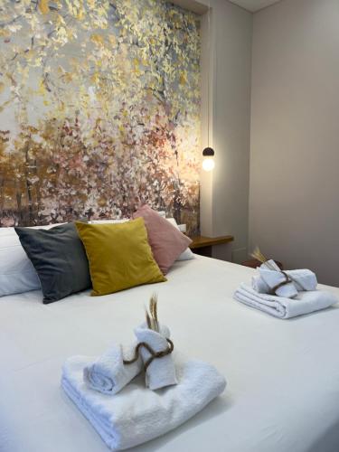 a bedroom with a bed with towels on it at DomusBiri in Bracciano