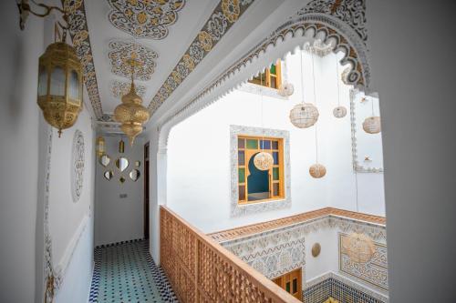 a hallway with a staircase with a moroccan inspired ceiling at Dar Golden Ziat in Fès